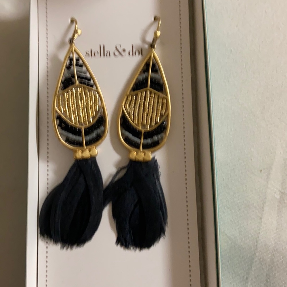 Earrings with black and gold beading and feather